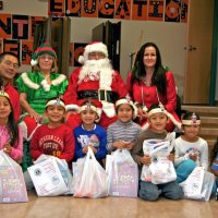 12/17/10 - Annual Christmas with Santa - Mission Education Center, San Francisco - The teacher and first grade students pose with Santa and his Elves.