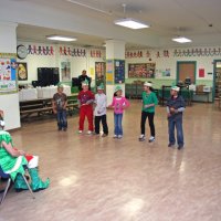 12/17/10 - Annual Christmas with Santa - Mission Education Center, San Francisco - The second grade class performs their song for Santa and his Eleves.