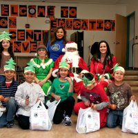 12/17/10 - Annual Christmas with Santa - Mission Education Center, San Francisco - The teacher and second grade students pose with Santa and his Elves.