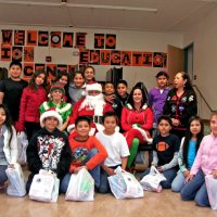 12/17/10 - Annual Christmas with Santa - Mission Education Center, San Francisco - The teacher and students, perhaps fifth graders, pose with Santa and his Elves.