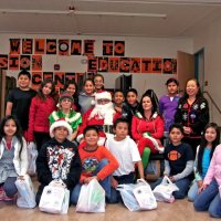 12/17/10 - Annual Christmas with Santa - Mission Education Center, San Francisco - The teacher and students, perhaps fifth graders, pose with Santa and his Elves.