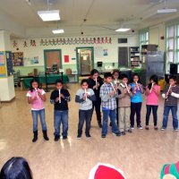 12/17/10 - Annual Christmas with Santa - Mission Education Center, San Francisco - A class, perhaps fourth graders, performs their musical number using recorders, as Santa and his Eleves look on.