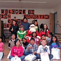 12/17/10 - Annual Christmas with Santa - Mission Education Center, San Francisco - The teacher and students, perhaps fourth graders, pose with Santa and his Elves.