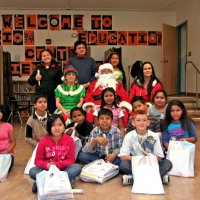 12/17/10 - Annual Christmas with Santa - Mission Education Center, San Francisco - The teacher and students, perhaps fourth graders, pose with Santa and his Elves.