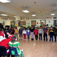 12/17/10 - Annual Christmas with Santa - Mission Education Center, San Francisco - The third grade class performs as their teacher, Principal Deborah Molof, and Santa & Company look on.