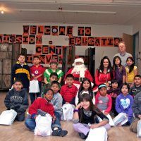 12/17/10 - Annual Christmas with Santa - Mission Education Center, San Francisco - The teacher and third grade students pose with Santa and his Elves.
