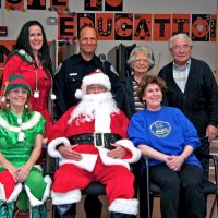 12/17/10 - Annual Christmas with Santa - Mission Education Center, San Francisco - L to R; back row: elf, SFPD officer, and Emily & Joe Farrah; front row: elf, Santa, played by SFPD Officer “Nacho” Martinez, and Principal Deborah Molof. Santa’s elves were Nancy Andelin and Terri Majors.