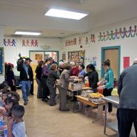 11/19/10 - Annual Thanksgiving Luncheon - Mission Education Center, San Francisco - Dishing up the food, behind the table, far end, l to r: Aaron Straus, cafeteria worker, Al Gentile, and Aline Thomas. Robert Quinn is nearest on this side of table.