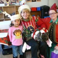 12/16/11 - Annual Christmas with Santa - Mission Education Center, San Francisco - Ms. Linda as Santa, with her dog Emma, and Jackie Cash as her Elf - Each student takes turns posing with Santa.