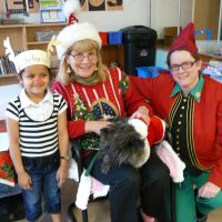 12/16/11 - Annual Christmas with Santa - Mission Education Center, San Francisco - Ms. Linda as Santa, with her dog Emma, and Jackie Cash as her Elf - Each student takes turns posing with Santa.