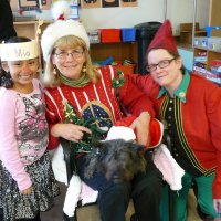 12/16/11 - Annual Christmas with Santa - Mission Education Center, San Francisco - Ms. Linda as Santa, with her dog Emma, and Jackie Cash as her Elf - Each student takes turns posing with Santa.