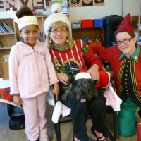 12/16/11 - Annual Christmas with Santa - Mission Education Center, San Francisco - Ms. Linda as Santa, with her dog Emma, and Jackie Cash as her Elf - Each student takes turns posing with Santa.