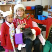 12/16/11 - Annual Christmas with Santa - Mission Education Center, San Francisco - Ms. Linda as Santa, with her dog Emma, and Jackie Cash as her Elf - Each student takes turns posing with Santa.