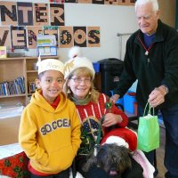 12/16/11 - Annual Christmas with Santa - Mission Education Center, San Francisco - Ms. Linda as Santa, with her dog Emma - Each student takes turns posing with Santa. Al Gentile, on right, hands Santa a gift for each student.