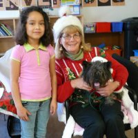 12/16/11 - Annual Christmas with Santa - Mission Education Center, San Francisco - Ms. Linda as Santa, with her dog Emma - Each student takes turns posing with Santa.