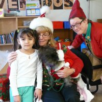 12/16/11 - Annual Christmas with Santa - Mission Education Center, San Francisco - Ms. Linda as Santa, with her dog Emma, and Jackie Cash as her Elf - Each student takes turns posing with Santa.