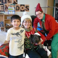 12/16/11 - Annual Christmas with Santa - Mission Education Center, San Francisco - Ms. Linda as Santa, with her dog Emma, and Jackie Cash as her Elf - Each student takes turns posing with Santa.