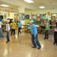 12/16/11 - Annual Christmas with Santa - Mission Education Center, San Francisco - A class doing a dance for Santa before posing and receiving their gift bags from Santa.