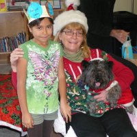 12/16/11 - Annual Christmas with Santa - Mission Education Center, San Francisco - Ms. Linda as Santa, with her dog Emma - Each student takes turns posing with Santa.