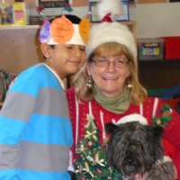 12/16/11 - Annual Christmas with Santa - Mission Education Center, San Francisco - Ms. Linda as Santa, with her dog Emma - Each student takes turns posing with Santa.