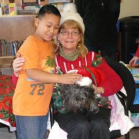 12/16/11 - Annual Christmas with Santa - Mission Education Center, San Francisco - Ms. Linda as Santa, with her dog Emma - Each student takes turns posing with Santa.