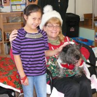 12/16/11 - Annual Christmas with Santa - Mission Education Center, San Francisco - Ms. Linda as Santa, with her dog Emma - Each student takes turns posing with Santa.