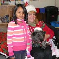 12/16/11 - Annual Christmas with Santa - Mission Education Center, San Francisco - Ms. Linda as Santa, with her dog Emma - Each student takes turns posing with Santa.