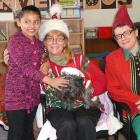 12/16/11 - Annual Christmas with Santa - Mission Education Center, San Francisco - Ms. Linda as Santa, with her dog Emma, and Jackie Cash as her Elf - Each student takes turns posing with Santa.