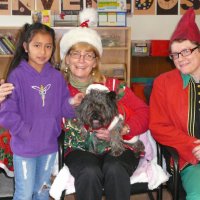 12/16/11 - Annual Christmas with Santa - Mission Education Center, San Francisco - Ms. Linda as Santa, with her dog Emma, and Jackie Cash as her Elf - Each student takes turns posing with Santa.