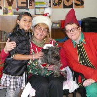 12/16/11 - Annual Christmas with Santa - Mission Education Center, San Francisco - Ms. Linda as Santa, with her dog Emma, and Jackie Cash as her Elf - Each student takes turns posing with Santa.