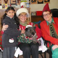 12/16/11 - Annual Christmas with Santa - Mission Education Center, San Francisco - Ms. Linda as Santa, with her dog Emma, and Jackie Cash as her Elf - Each student takes turns posing with Santa.