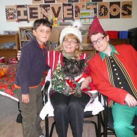 12/16/11 - Annual Christmas with Santa - Mission Education Center, San Francisco - Ms. Linda as Santa, with her dog Emma, and Jackie Cash as her Elf - Each student takes turns posing with Santa.