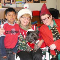 12/16/11 - Annual Christmas with Santa - Mission Education Center, San Francisco - Ms. Linda as Santa, with her dog Emma, and Jackie Cash as her Elf - Each student takes turns posing with Santa.