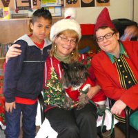 12/16/11 - Annual Christmas with Santa - Mission Education Center, San Francisco - Ms. Linda as Santa, with her dog Emma, and Jackie Cash as her Elf - Each student takes turns posing with Santa.