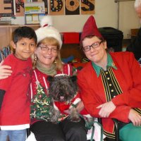 12/16/11 - Annual Christmas with Santa - Mission Education Center, San Francisco - Ms. Linda as Santa, with her dog Emma, and Jackie Cash as her Elf - Each student takes turns posing with Santa.