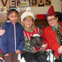 12/16/11 - Annual Christmas with Santa - Mission Education Center, San Francisco - Ms. Linda as Santa, with her dog Emma, and Jackie Cash as her Elf - Each student takes turns posing with Santa.