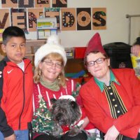 12/16/11 - Annual Christmas with Santa - Mission Education Center, San Francisco - Ms. Linda as Santa, with her dog Emma, and Jackie Cash as her Elf - Each student takes turns posing with Santa.