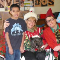 12/16/11 - Annual Christmas with Santa - Mission Education Center, San Francisco - Ms. Linda as Santa, with her dog Emma, and Jackie Cash as her Elf - Each student takes turns posing with Santa.