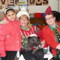 12/16/11 - Annual Christmas with Santa - Mission Education Center, San Francisco - Ms. Linda as Santa, with her dog Emma, and Jackie Cash as her Elf - Each student takes turns posing with Santa.