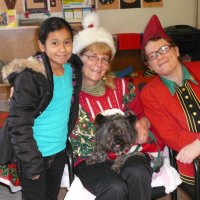 12/16/11 - Annual Christmas with Santa - Mission Education Center, San Francisco - Ms. Linda as Santa, with her dog Emma, and Jackie Cash as her Elf - Each student takes turns posing with Santa.