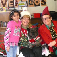 12/16/11 - Annual Christmas with Santa - Mission Education Center, San Francisco - Ms. Linda as Santa, with her dog Emma, and Jackie Cash as her Elf - Each student takes turns posing with Santa.