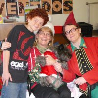 12/16/11 - Annual Christmas with Santa - Mission Education Center, San Francisco - Ms. Linda as Santa, with her dog Emma, and Jackie Cash as her Elf - Each student takes turns posing with Santa.