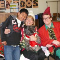 12/16/11 - Annual Christmas with Santa - Mission Education Center, San Francisco - Ms. Linda as Santa, with her dog Emma, and Jackie Cash as her Elf - Each student takes turns posing with Santa.