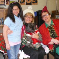 12/16/11 - Annual Christmas with Santa - Mission Education Center, San Francisco - Ms. Linda as Santa, with her dog Emma, and Jackie Cash as her Elf - Each student takes turns posing with Santa.