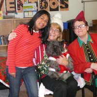 12/16/11 - Annual Christmas with Santa - Mission Education Center, San Francisco - Ms. Linda as Santa, with her dog Emma, and Jackie Cash as her Elf - Each student takes turns posing with Santa.