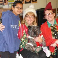 12/16/11 - Annual Christmas with Santa - Mission Education Center, San Francisco - Ms. Linda as Santa, with her dog Emma, and Jackie Cash as her Elf - Each student takes turns posing with Santa.