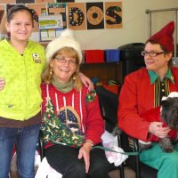 12/16/11 - Annual Christmas with Santa - Mission Education Center, San Francisco - Ms. Linda as Santa, with her dog Emma, and Jackie Cash as her Elf - Each student takes turns posing with Santa.