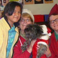 12/16/11 - Annual Christmas with Santa - Mission Education Center, San Francisco - Ms. Linda as Santa, with her dog Emma, and Jackie Cash as her Elf - Each student takes turns posing with Santa.