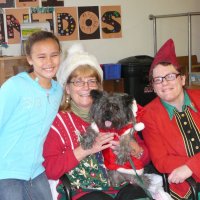 12/16/11 - Annual Christmas with Santa - Mission Education Center, San Francisco - Ms. Linda as Santa, with her dog Emma, and Jackie Cash as her Elf - Each student takes turns posing with Santa.