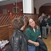 2/19/11 - 28th Annual Castagnetto / Spediacci Memorial Crab Feed - Italian American Social Club, San Francisco - Linda Workman, left, talking with Bre Jones just as the event is beginning. Others coming in and checking in.